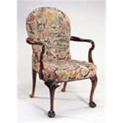 A walnut open armchair in George I style, the rounded back and seat in gros and petit point woolwork