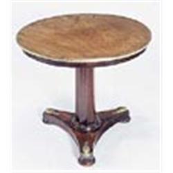 A mahogany table, the round top with brass band on octagonal tapering column and concave platform wi