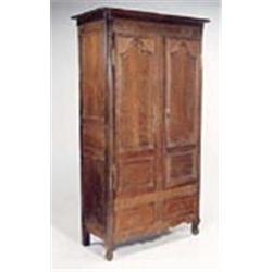 A late 18th century French oak provincial armoire, the concave cornice with rounded corners above tw