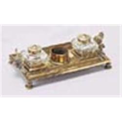 A 19th century brass rectangular inkstand, with leaf chased handles, two cut glass wells and a centr