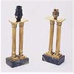 A pair of brass lamp bases, each in the form of two leaf capped fluted columns, on rectangular green