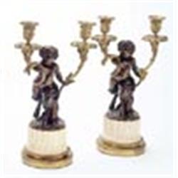 A pair of mid 19th century French bronze candelabra, after Clodion, each in the form of a faun, supp