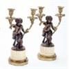A pair of mid 19th century French bronze candelabra, after Clodion, each in the form of a faun, supp