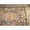 A 19th century European needlework rug, worked in coloured wools with a central diaper flowerhead me