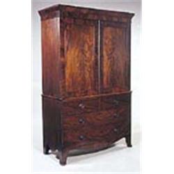 An early 19th century mahogany clothes press,with moulded cornice and two panelled doors above two s