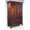 An early 19th century mahogany clothes press,with moulded cornice and two panelled doors above two s