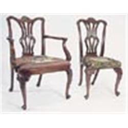 A set of ten mahogany dining chairs, each with a leaf carved serpentine crest rail, a vase shaped sp