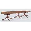 An early 19th century mahogany 'D' end triple pedestal dining table, the top with a reeded edge and