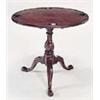 Image 1 : A George III mahogany and fruitwood games table, the round tilt top with four counter wells and a le