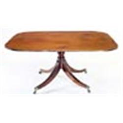 A Regency mahogany breakfast table, the rectangular tilt top with rounded corners and an ebony strun