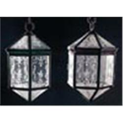 A pair of hexagonal lead lanterns, the glazed panels etched in Dutch style with scrolls and flowers,