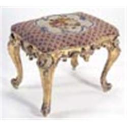 A 19th century gilt wood and gesso stool of serpentine form, with a bead and woolwork  seat, on cabr