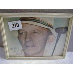 A FRAMED COLOUR PHOTOGRAPH, BING CROSBY PLAYING GOLF, SIGNED "ALL THE BEST BING".