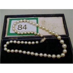 String of pearls set with 14ct platinum and diamond clasp.