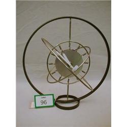 Unusual gyroscopic metal clock in working order.