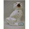 Large Staffordshire white and gilt spaniel, hairline crack to base.