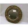 Oval bevelled edged mirror surrounded by pierced metal frame decorated with cherubs and griffins.