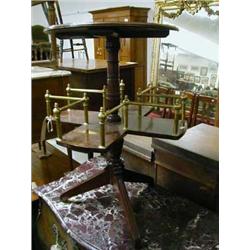 Late 19th century mahogany decanter table on tripod legs with shaped brass guard revolving centre, i