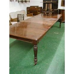Late 19th century mahogany extending dining table with four original leaves on five turned and taper