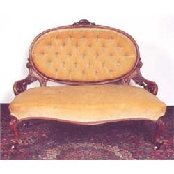A  Victorian  walnut  framed settee, the ova