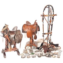 Grouping of Western Décor Including a Saddle and Belt Buckles