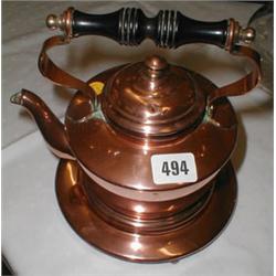 A C19th copper kettle with ebonised handle...