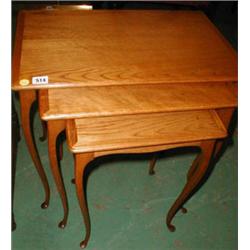 A nest of three oak tables with fine serpe...