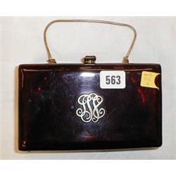 An oblong Lucite handbag with motif to fro...