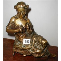 A C19th French brass reclining lady...