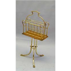 An Edwardian brass and oak magazine rack ...