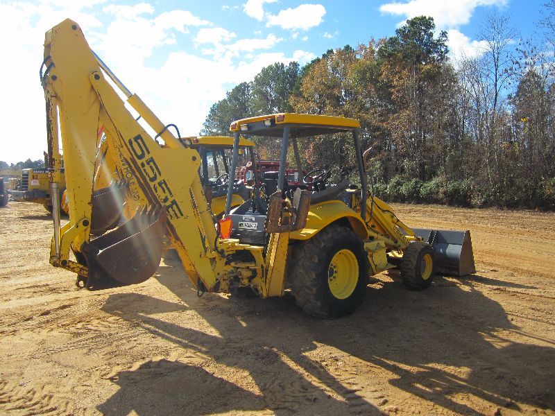 NEW HOLLAND 555E 4X4 LOADER BACKHOE J.M. Wood Auction Company, Inc.