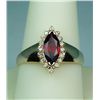 Image 1 : Stylish 14 karat yellow gold ladies ring set  with a center MQ cut garnet weighing approx.  2.00 car