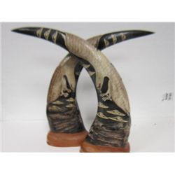 Pr carved horns with eagle design on wood bases