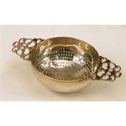 A Victorian silver strainer by Wakeley and...