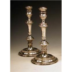 A pair of modern silver table candlesticks...