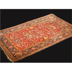 A Kashan wool rug, the wine red field exte...
