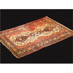A Sarouk wool rug, the central ivory field...