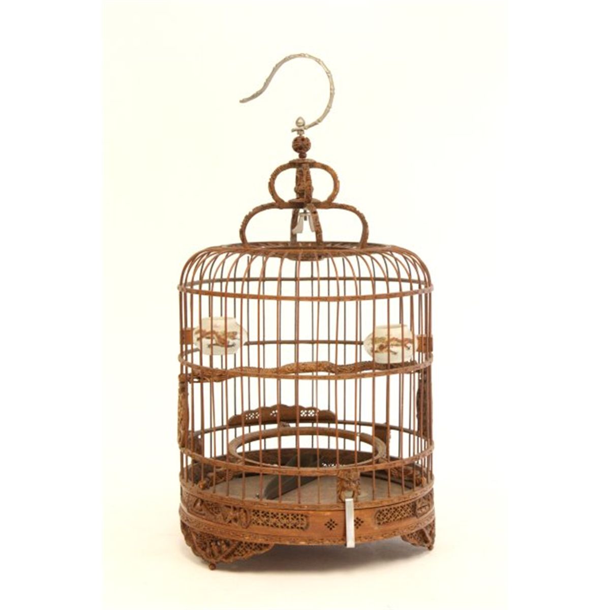 Carved Chinese bird cage with porcelain feeders