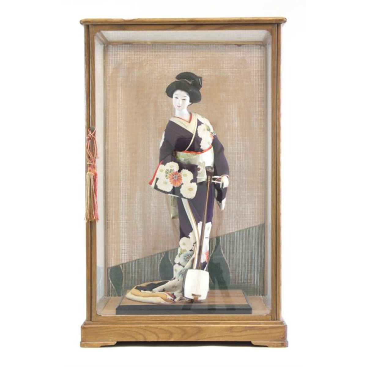 Japanese doll in glass box with wood frame