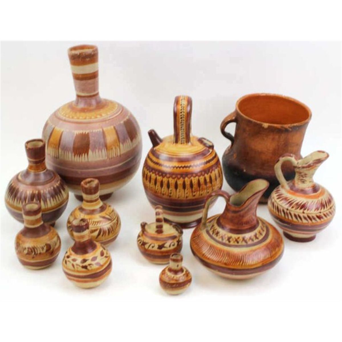 Collection of 11 Mexican pottery items includes 6 hand painted carafes