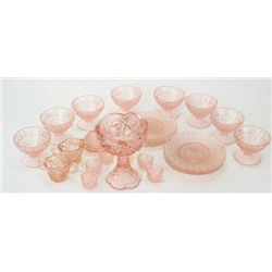 Collection of reproduction pink depression glass includes 8 saucers, 8 desserts and childs size set.