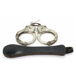 Collection of 2 includes S&W handcuffs with key, and Buchimer leather slap jack.