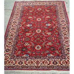 Kashan rug with trailing flowers on red ground