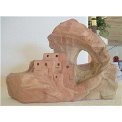 Pueblo with natural bridge carved from sandstone.