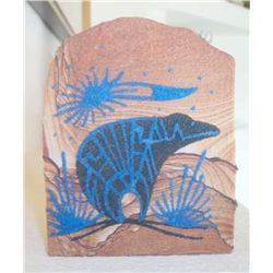 Etched sandstone Native American totem character.