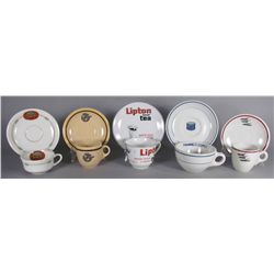 Five Sets of Cups and Saucers with Advertising