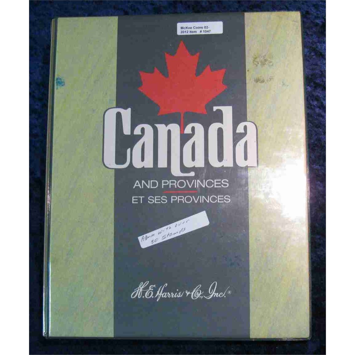 1047. Harris Canada Stamp Album with over 80 Used Stamps.