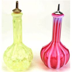 Collection of 2 antique barber bottles one in vasoline glass with daisy and fern pattern, the second