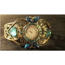 blue round face watch cuff bracelet