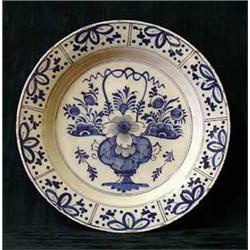 An antique Delft blue and white circular char...